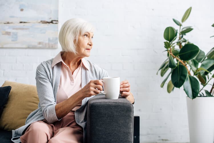 Senior woman sitting in her home.