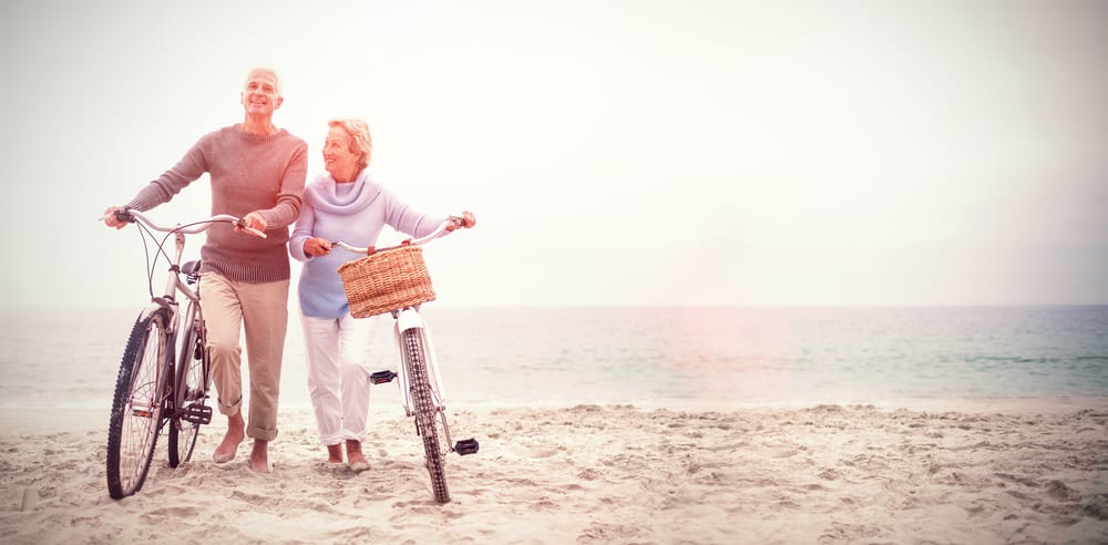 Seniors riding bikes on the beach