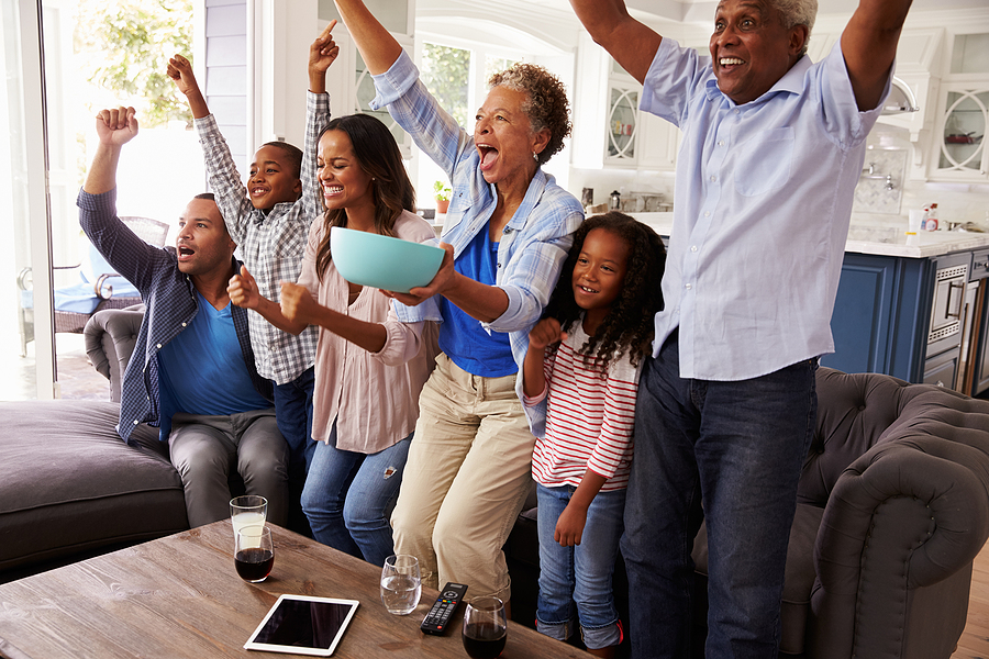 Family gathered and cheering around couch