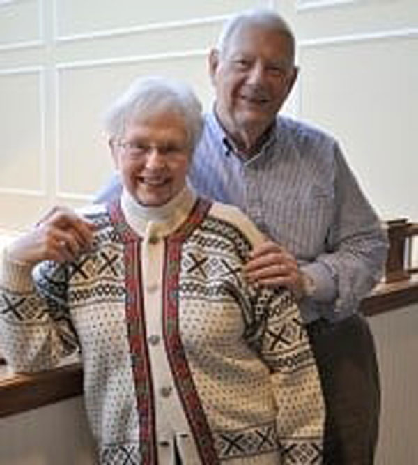 A senior couple pose for a photo