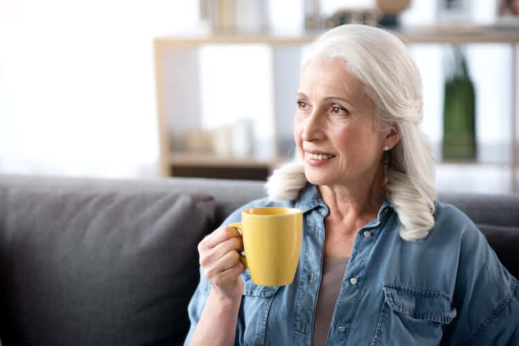 Senior enjoying a cup of tea while relaxing at home.