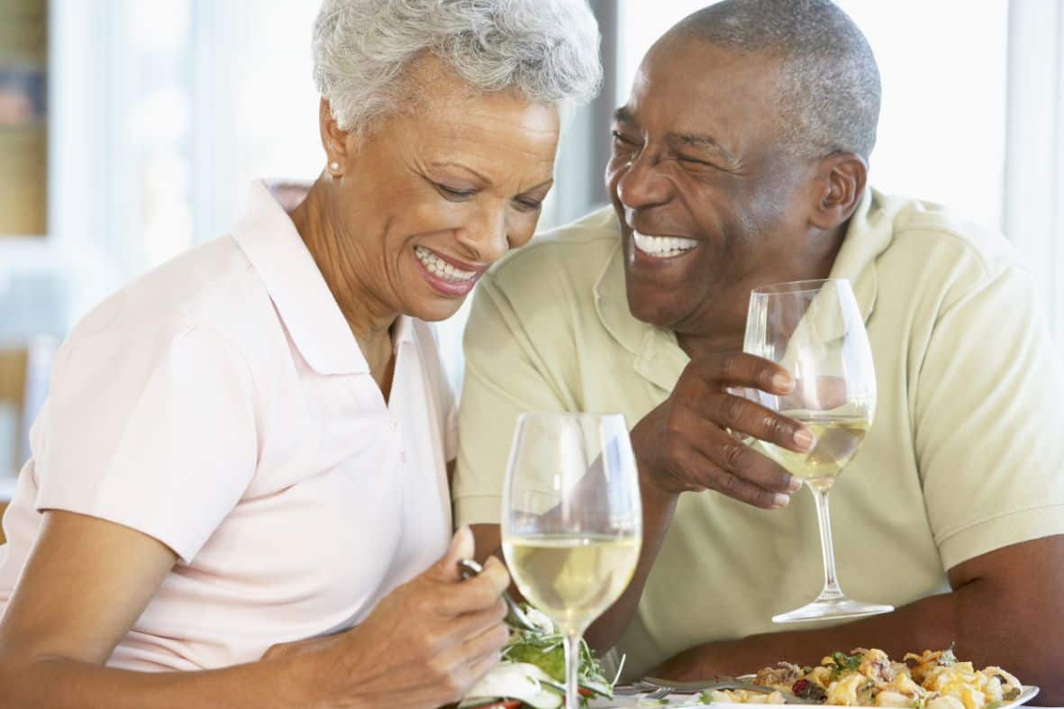 Couple enjoying a meal in their senior living community.