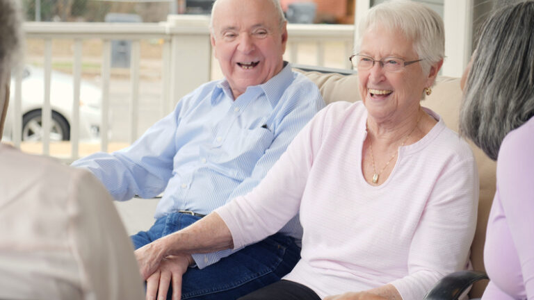Small Group of Seniors Smiling and Talking to One Another