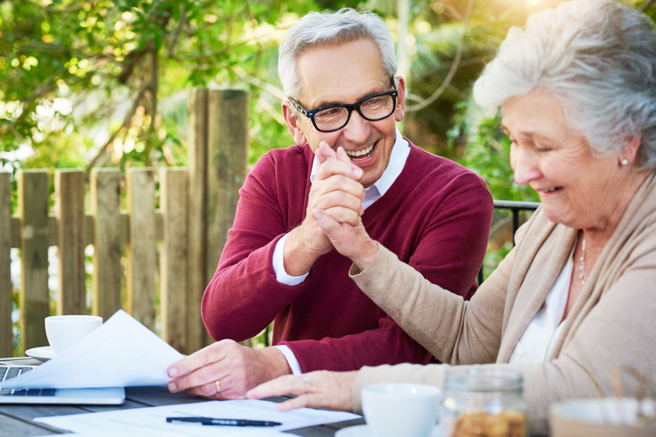Senior Couple Happily Reviewing Paperwork