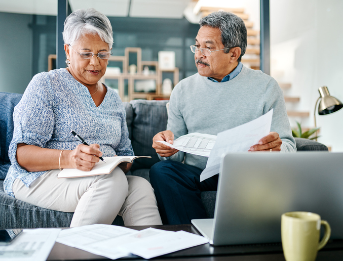 Senior Couple Completing Paperwork