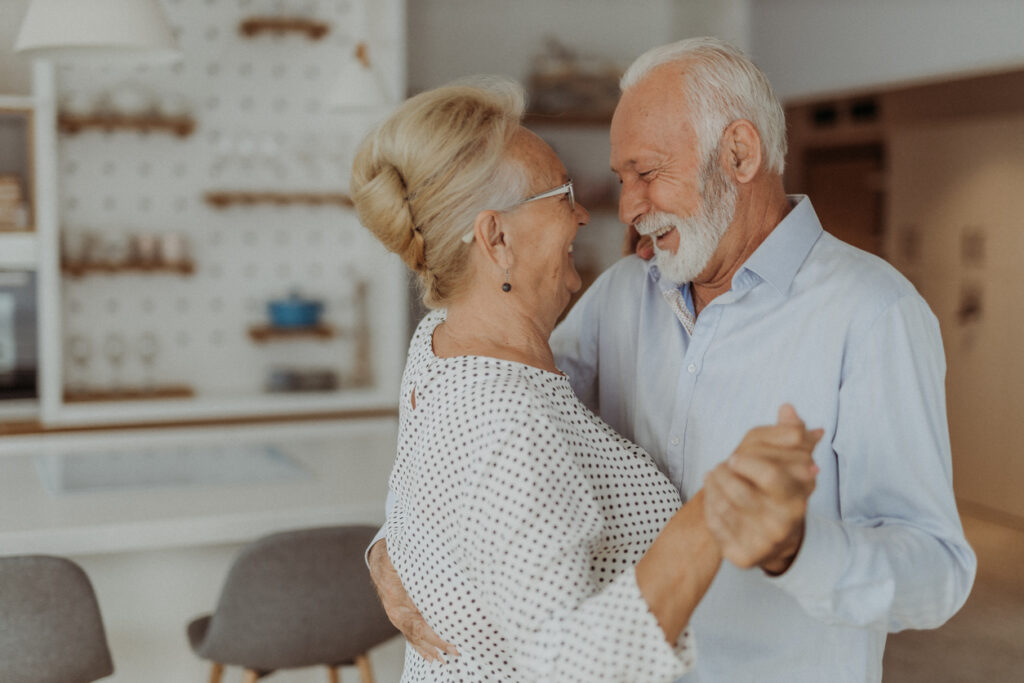 Senior Man and Woman Smiling at Each Other and Dancing