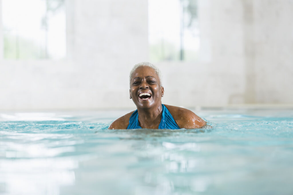 Senior Woman Smiling while Swimming